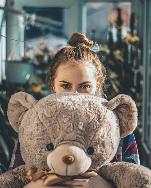 Girl hugs big bear weighted stuffed animal