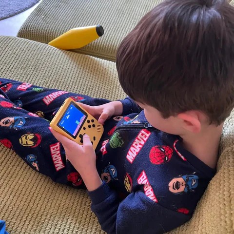 Boy playing GameTendo console